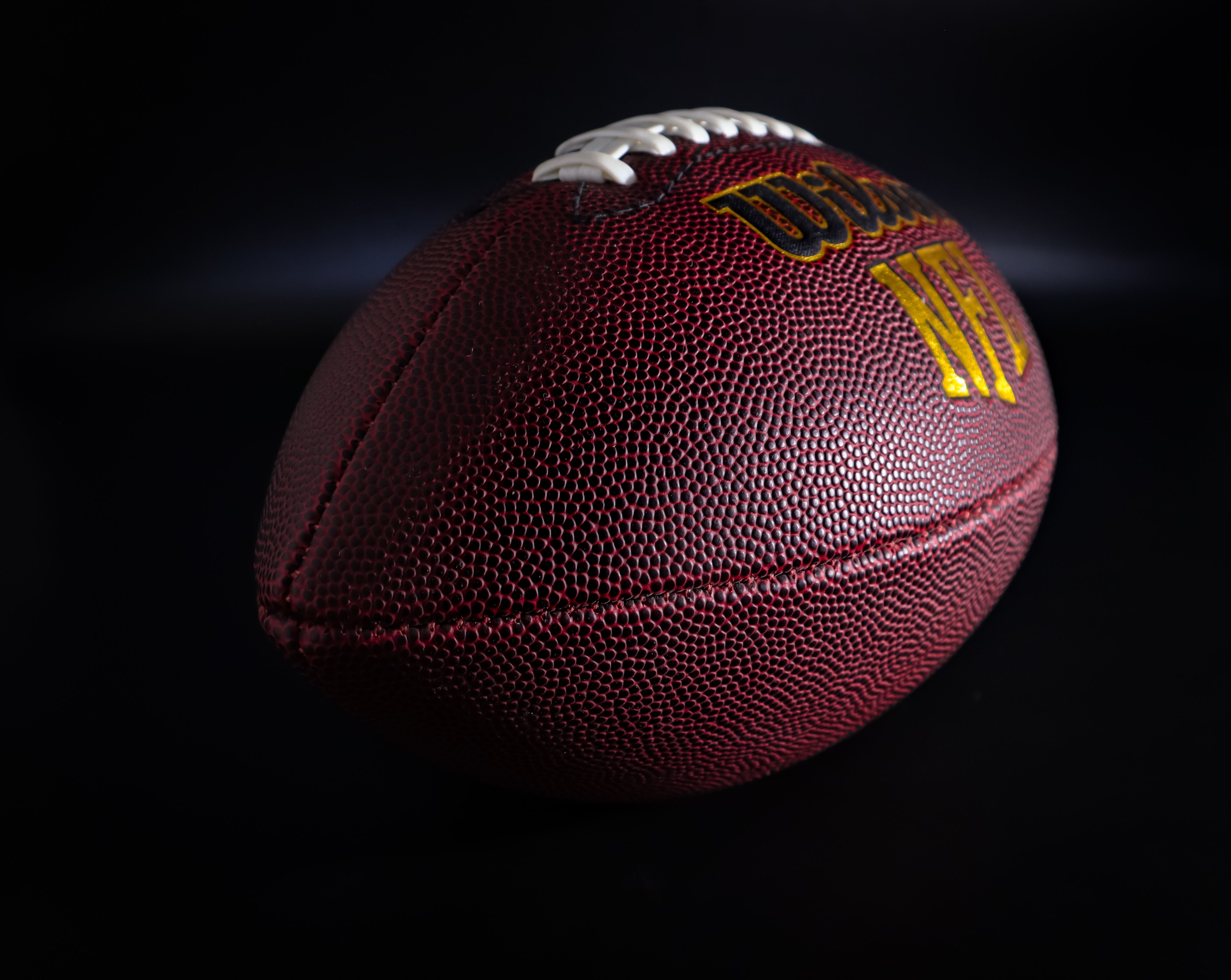 Close-up of a football against a dark background